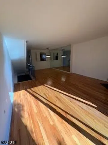 a spacious bedroom with a bed and a dresser in it