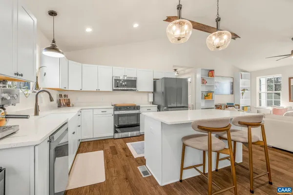 a kitchen with a sink stainless steel appliances and cabinets