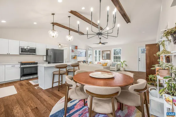 a kitchen with a dining table chairs stove and microwave
