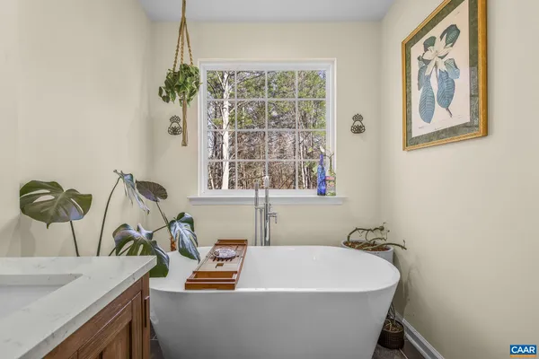a white bath tub sitting next to a window