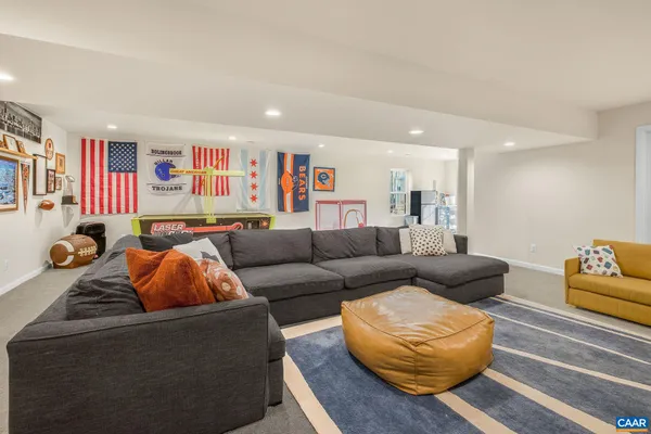 a living room with furniture and a book shelf
