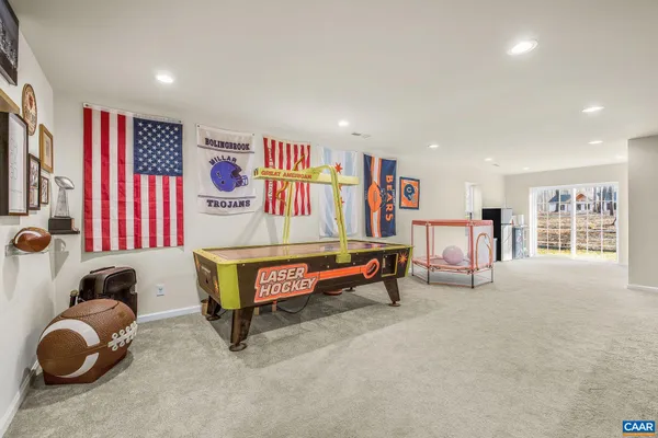 a living room with furniture and a book shelf