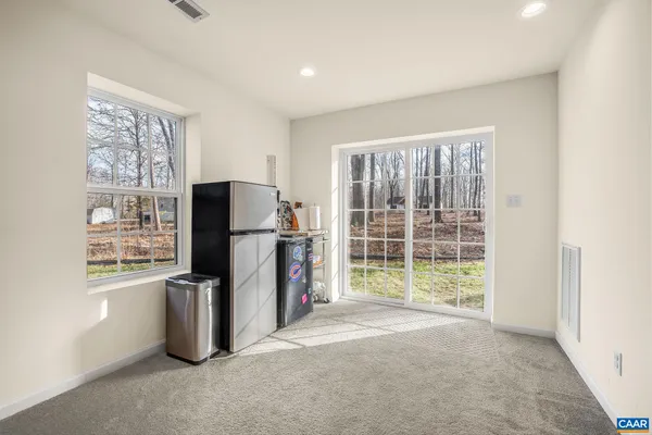 a view of a kitchen with refrigerator and windows