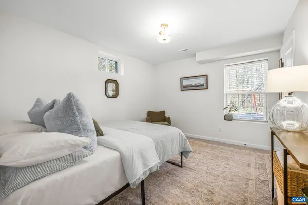 a bedroom with a bed and a lamp on table