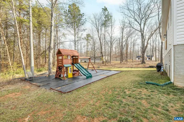 a view of outdoor space with playground and green space