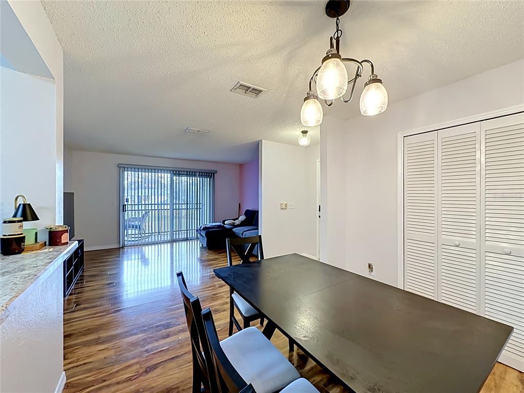 3705 Southwest 27th Street, Unit 922 Gainesville, FL 32608 - Photo 7 of 34 a view of a dining room with furniture and wooden floor