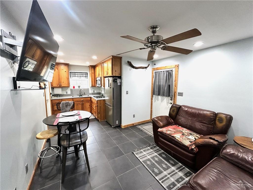5101 Mile 8 Road Edinburg, TX 78541 - Photo 5 of 18 a living room with furniture a ceiling fan and a rug