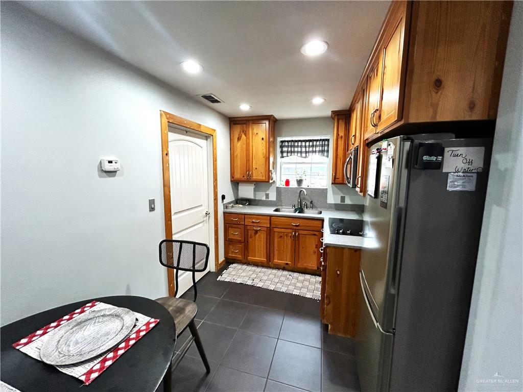 5101 Mile 8 Road Edinburg, TX 78541 - Photo 6 of 18 a kitchen with stainless steel appliances granite countertop a refrigerator and a stove top oven
