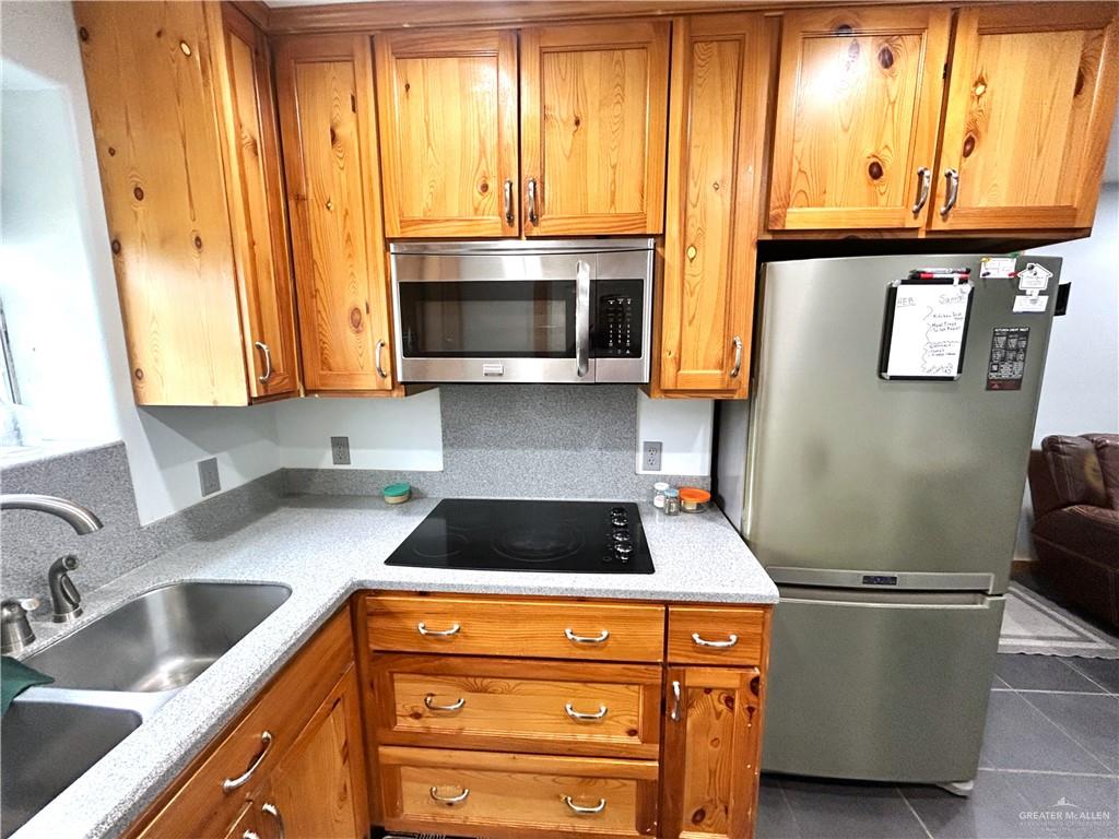 5101 Mile 8 Road Edinburg, TX 78541 - Photo 7 of 18 a kitchen with stainless steel appliances granite countertop a stove a sink and a microwave