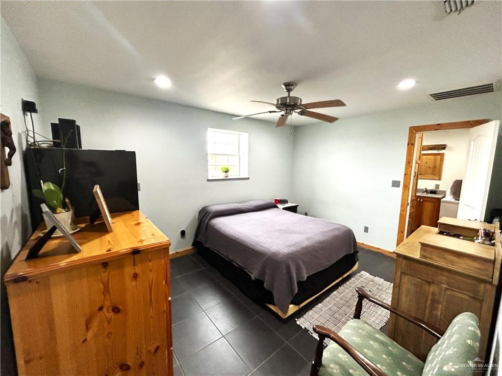 5101 Mile 8 Road Edinburg, TX 78541 - Photo 8 of 18 a bedroom with a bed and a flat screen tv