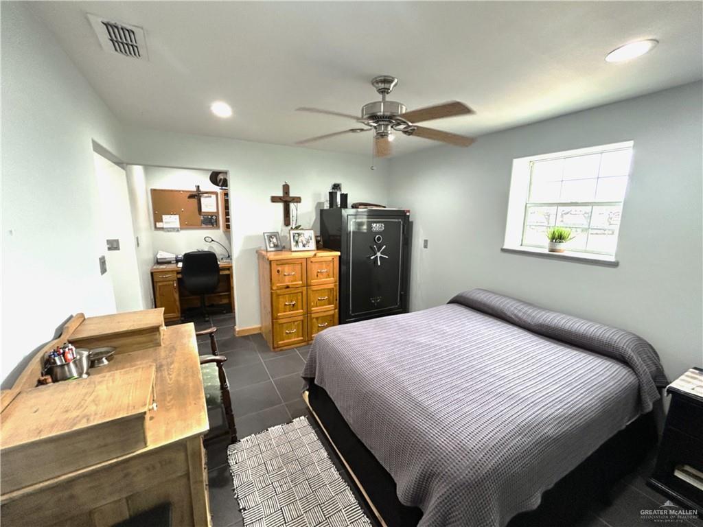 5101 Mile 8 Road Edinburg, TX 78541 - Photo 9 of 18 a bedroom with a bed and a chandelier