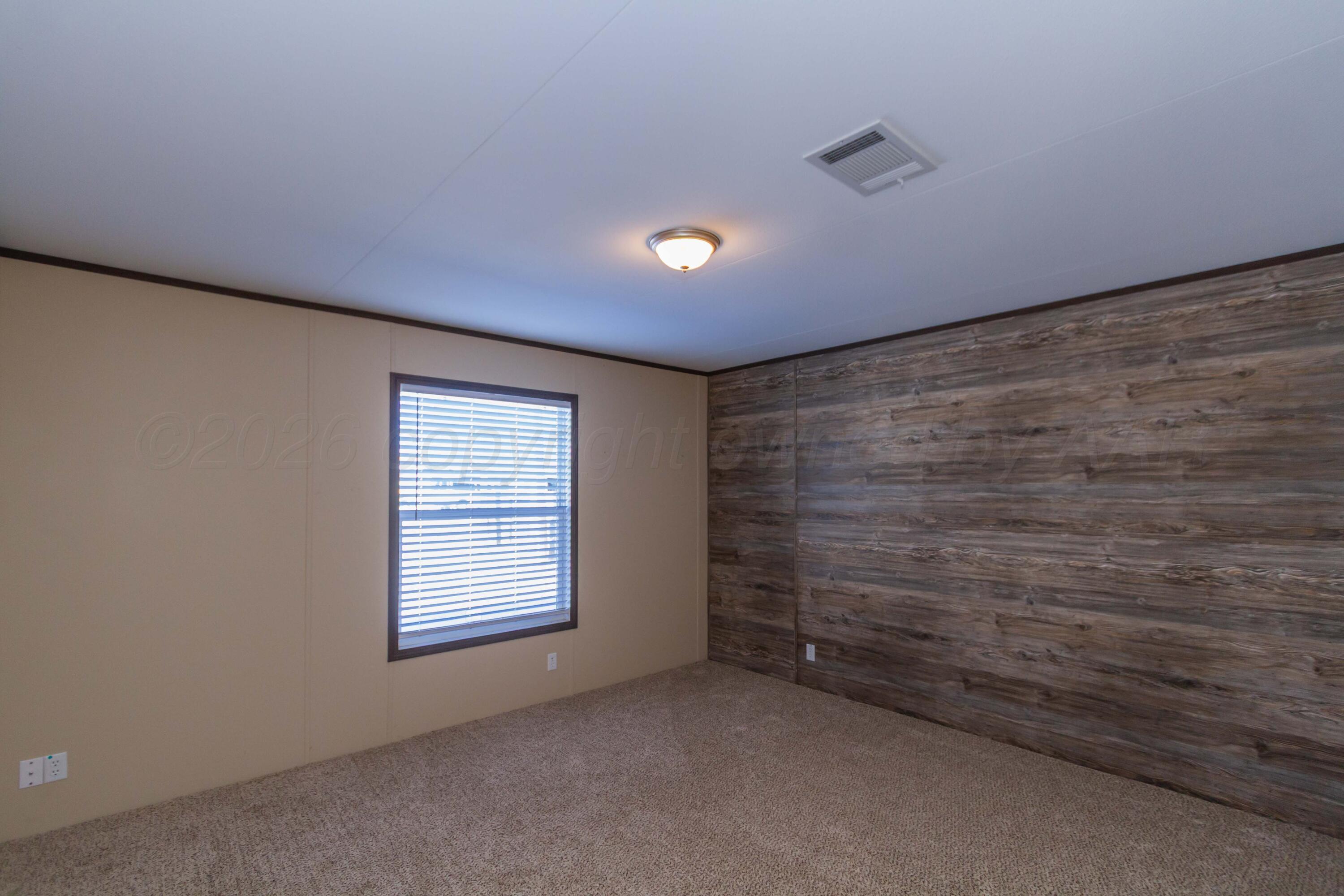 108 North Canadian Street Wheeler, TX 79096 - Photo 14 of 42 a view of an empty room with a window