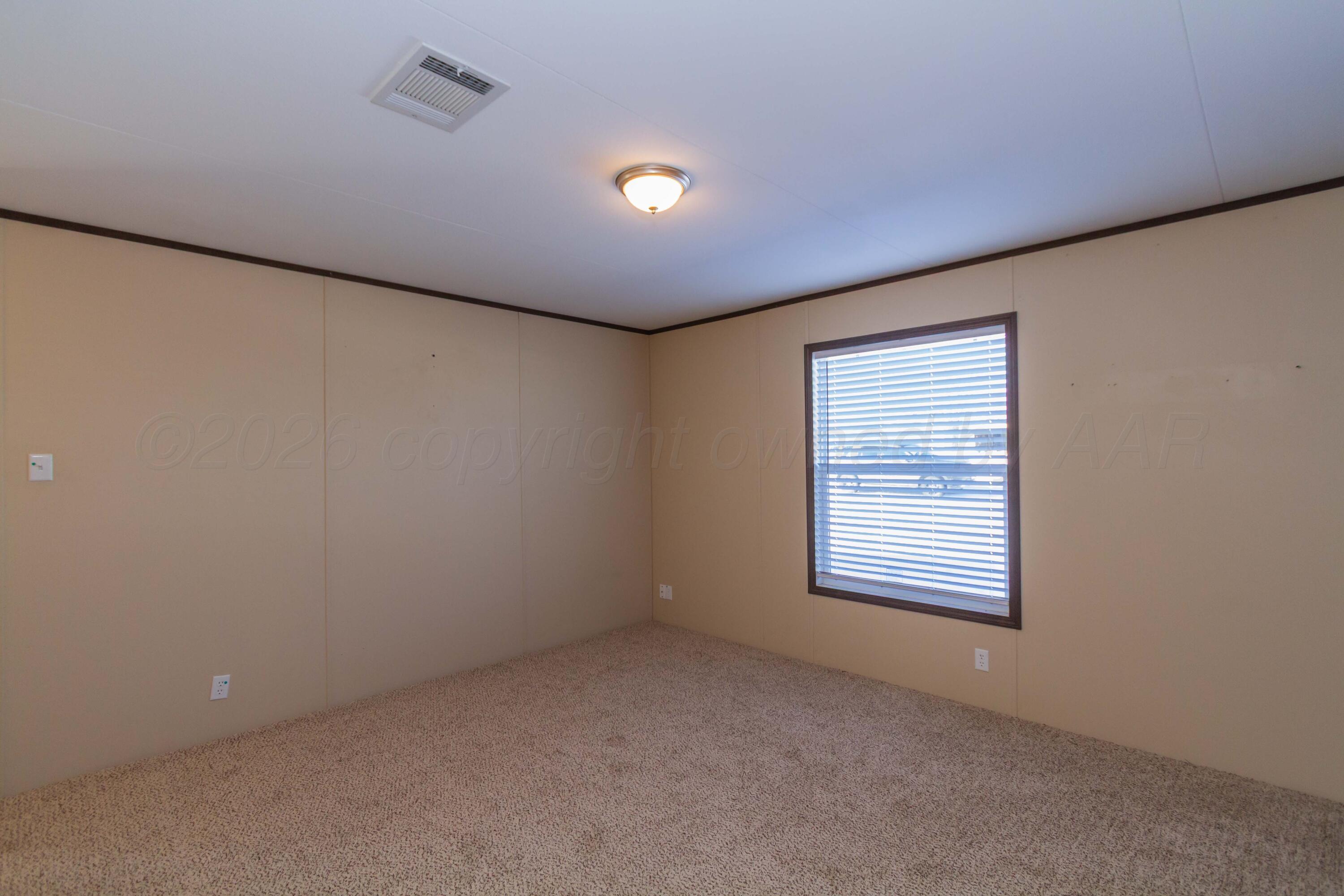 108 North Canadian Street Wheeler, TX 79096 - Photo 17 of 42 a view of an empty room with a window