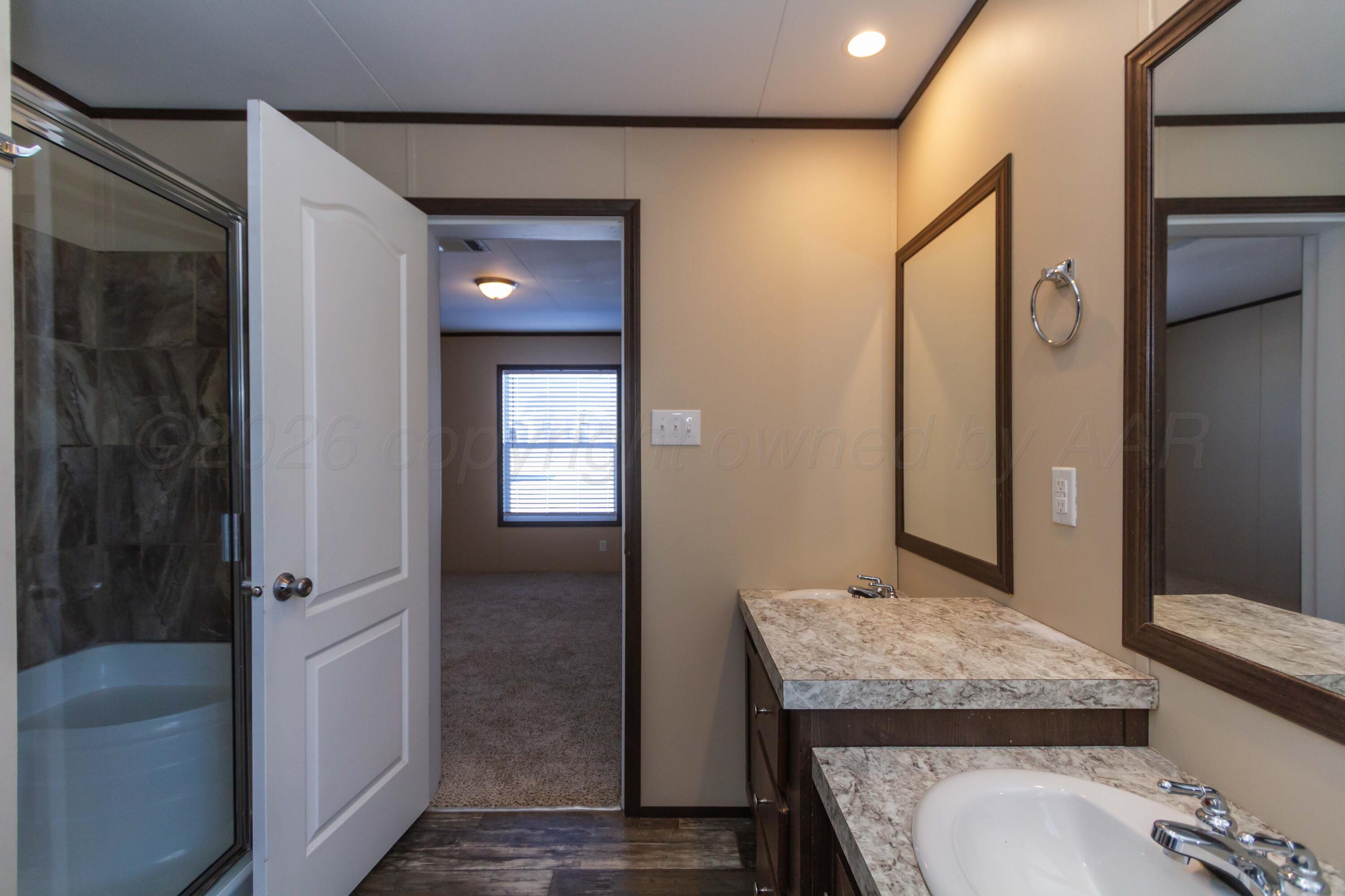108 North Canadian Street Wheeler, TX 79096 - Photo 20 of 42 a bathroom with a granite countertop sink and a mirror