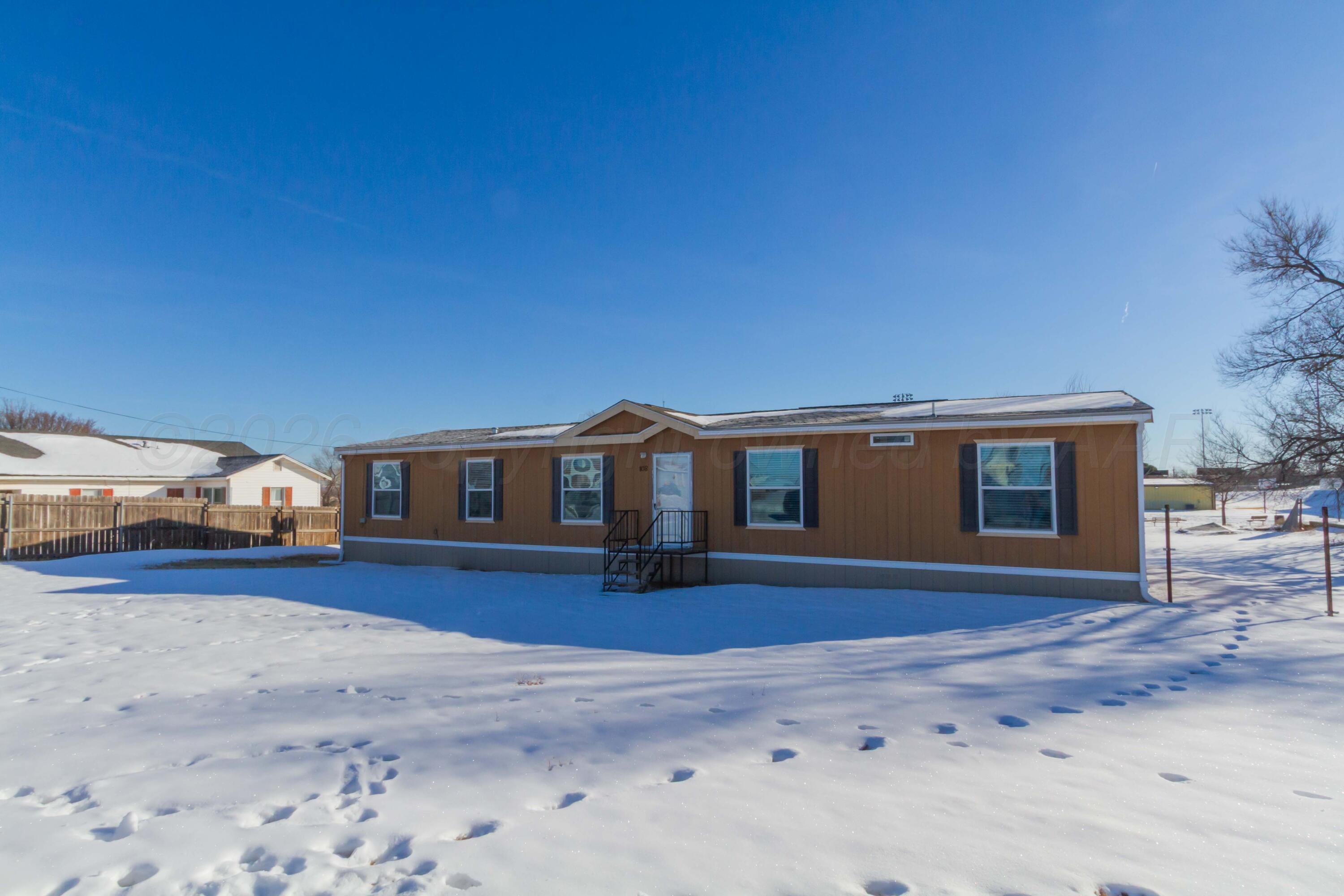 108 North Canadian Street Wheeler, TX 79096 - Photo 2 of 42 a front view of a house with a yard