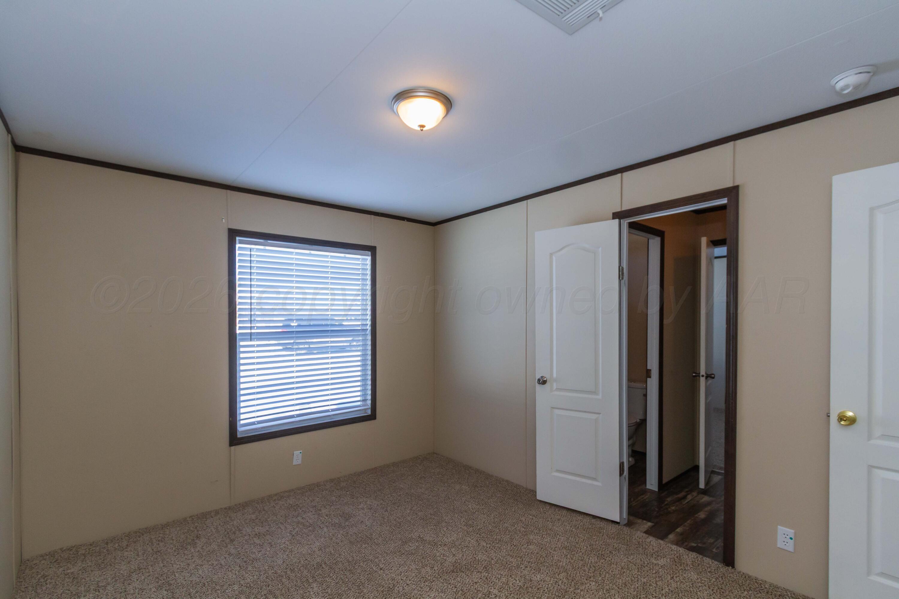 108 North Canadian Street Wheeler, TX 79096 - Photo 23 of 42 an empty room with windows and closet