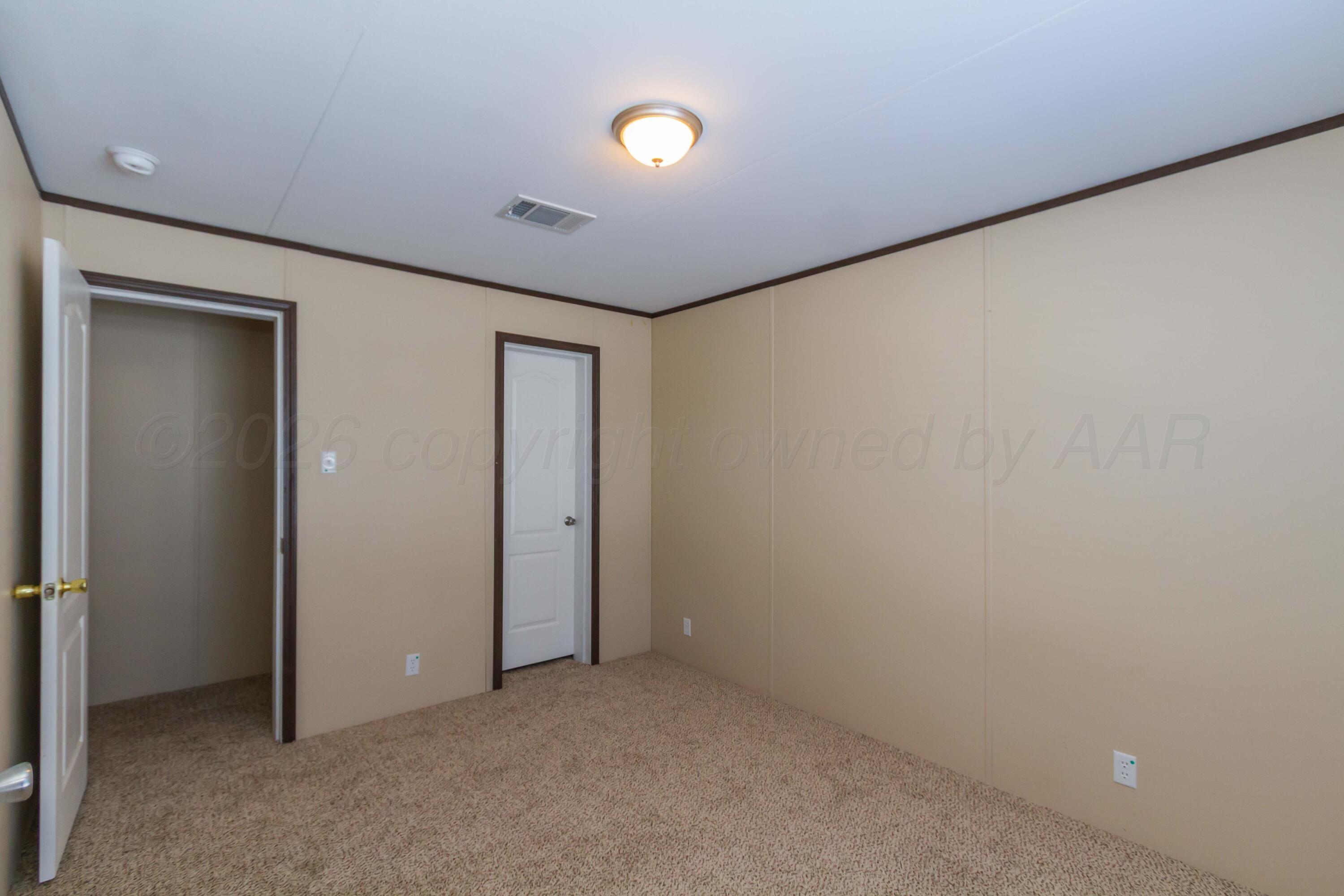 108 North Canadian Street Wheeler, TX 79096 - Photo 25 of 42 an empty room with a painting and a lamp