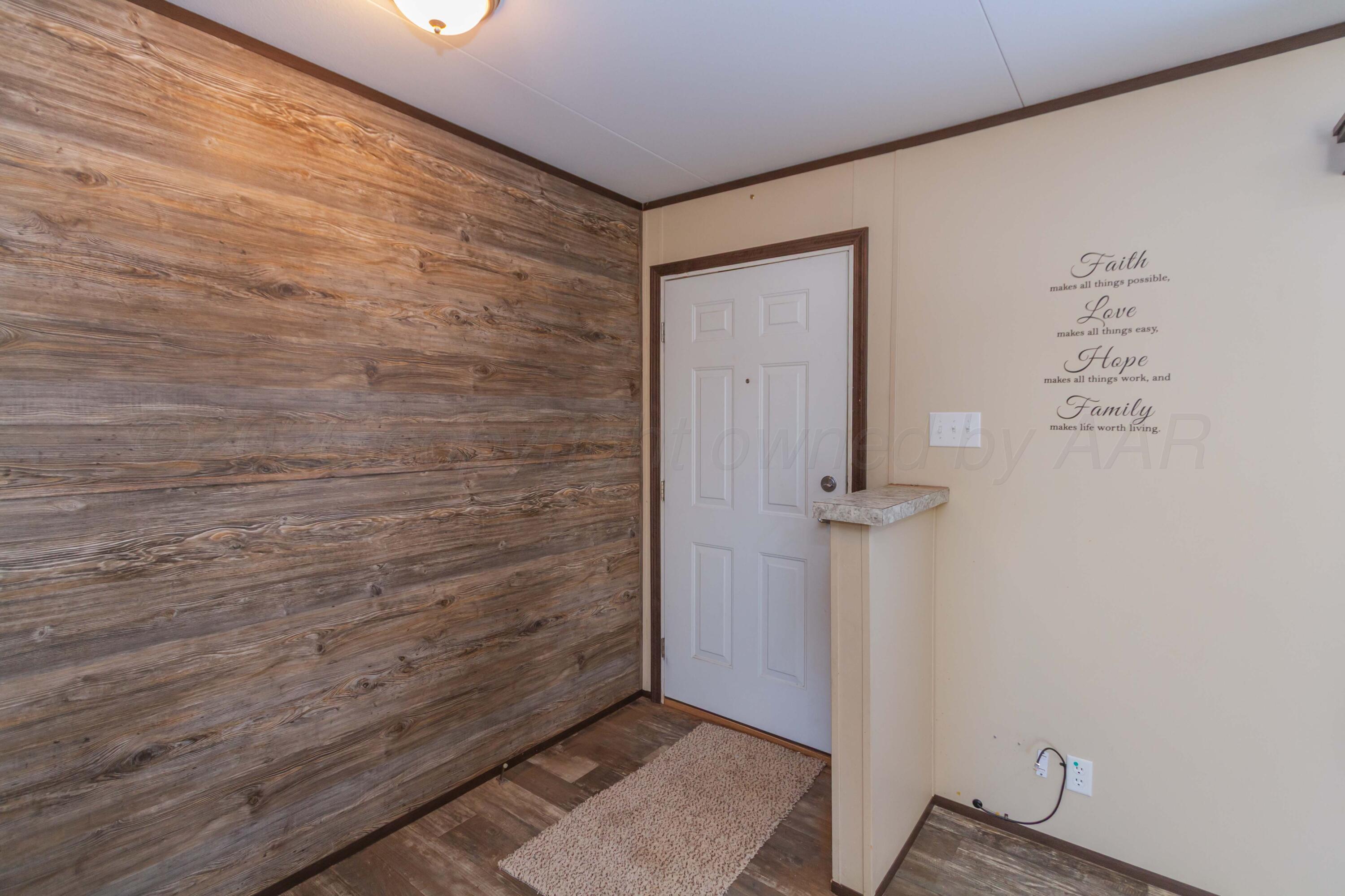 108 North Canadian Street Wheeler, TX 79096 - Photo 3 of 42 a view of a hallway with wooden floor
