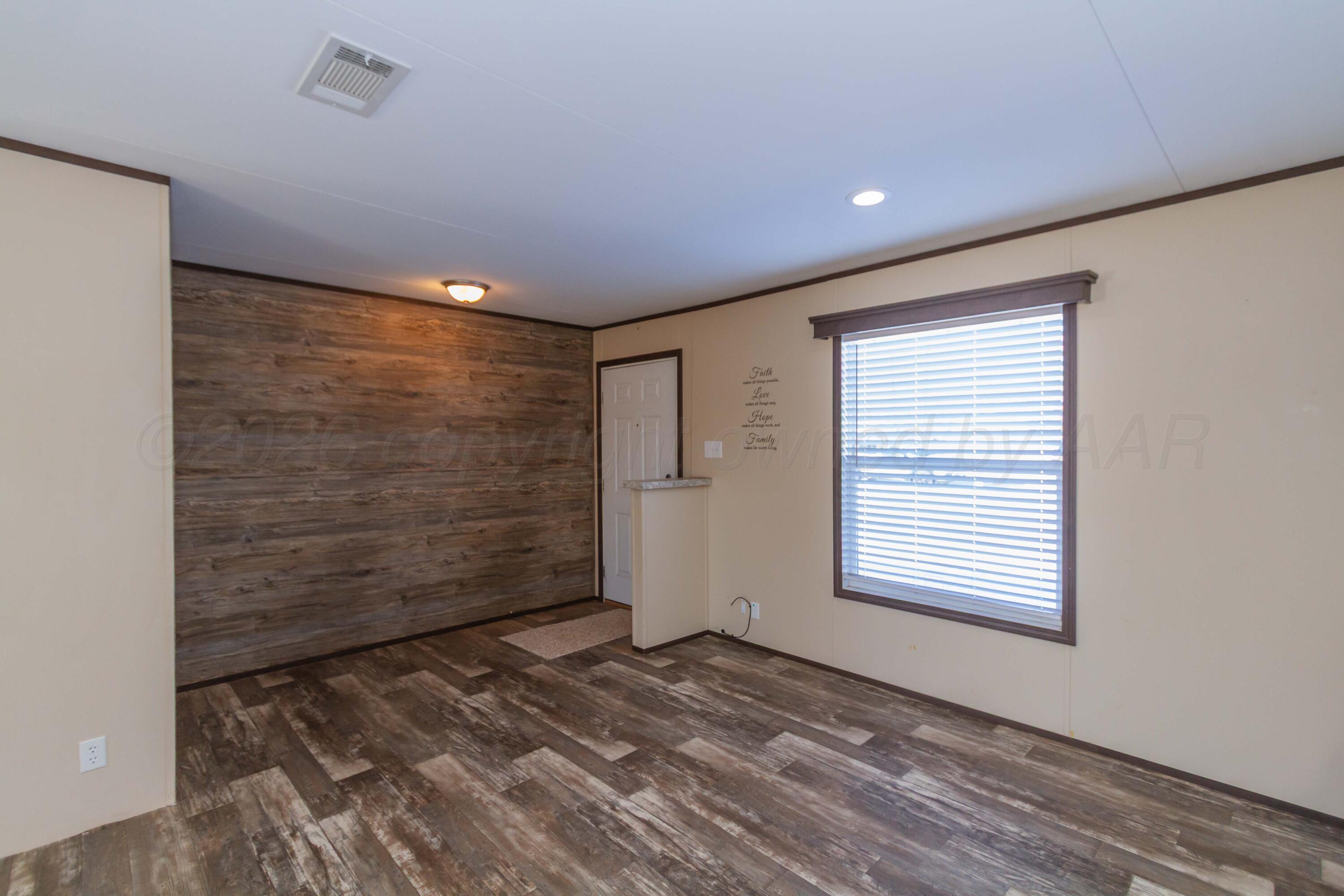 108 North Canadian Street Wheeler, TX 79096 - Photo 6 of 42 a view of an empty room with a window