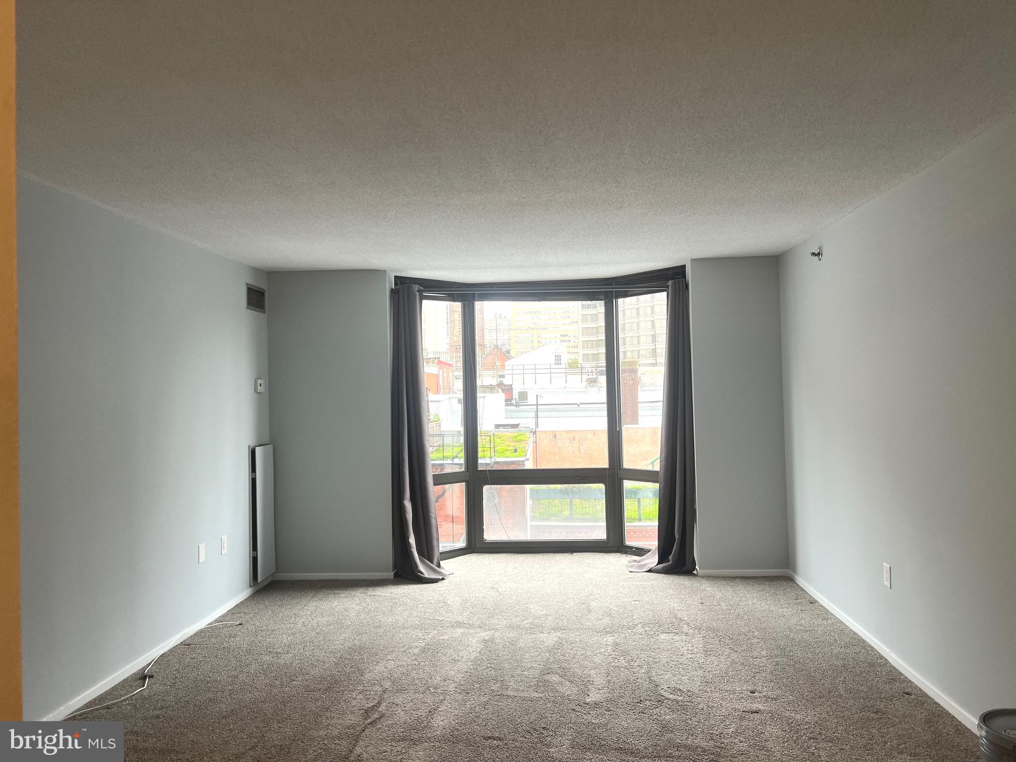 2020 Walnut Street, Unit 6C Philadelphia, PA 19103 - Photo 2 of 25 an empty room with large windows
