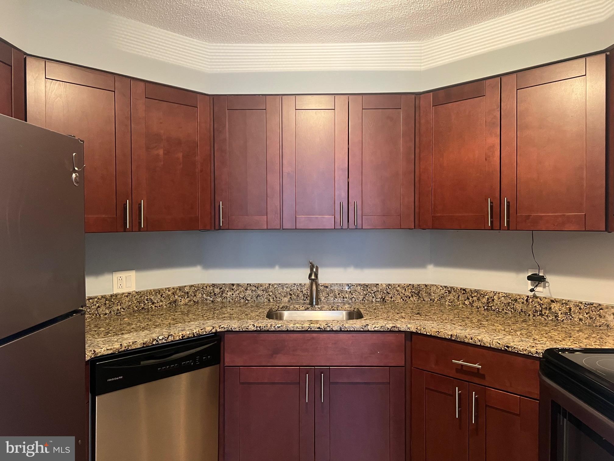 2020 Walnut Street, Unit 6C Philadelphia, PA 19103 - Photo 5 of 25 a kitchen with granite countertop cabinets sink and window