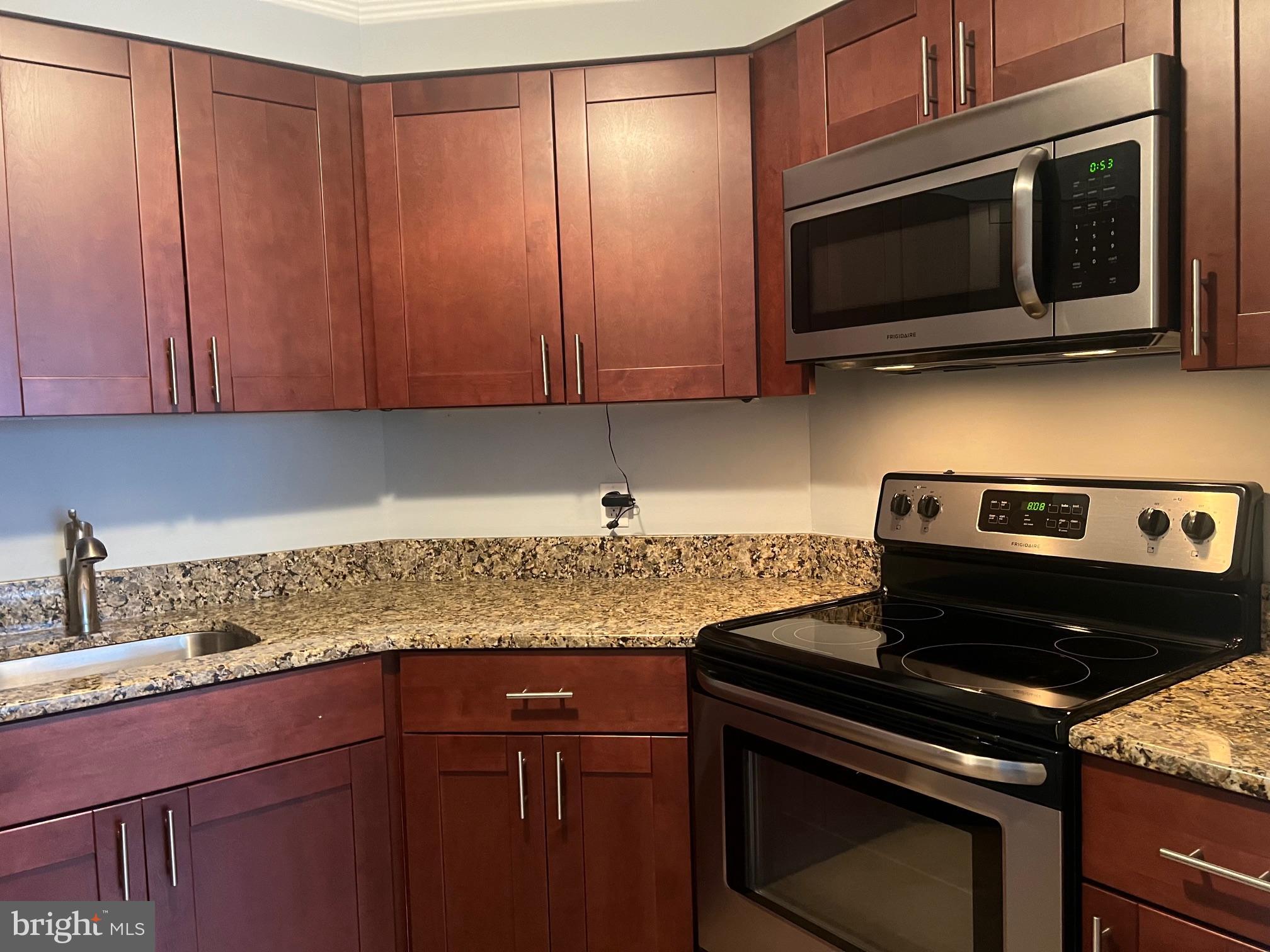 2020 Walnut Street, Unit 6C Philadelphia, PA 19103 - Photo 8 of 25 a kitchen with stainless steel appliances granite countertop a stove microwave and oven