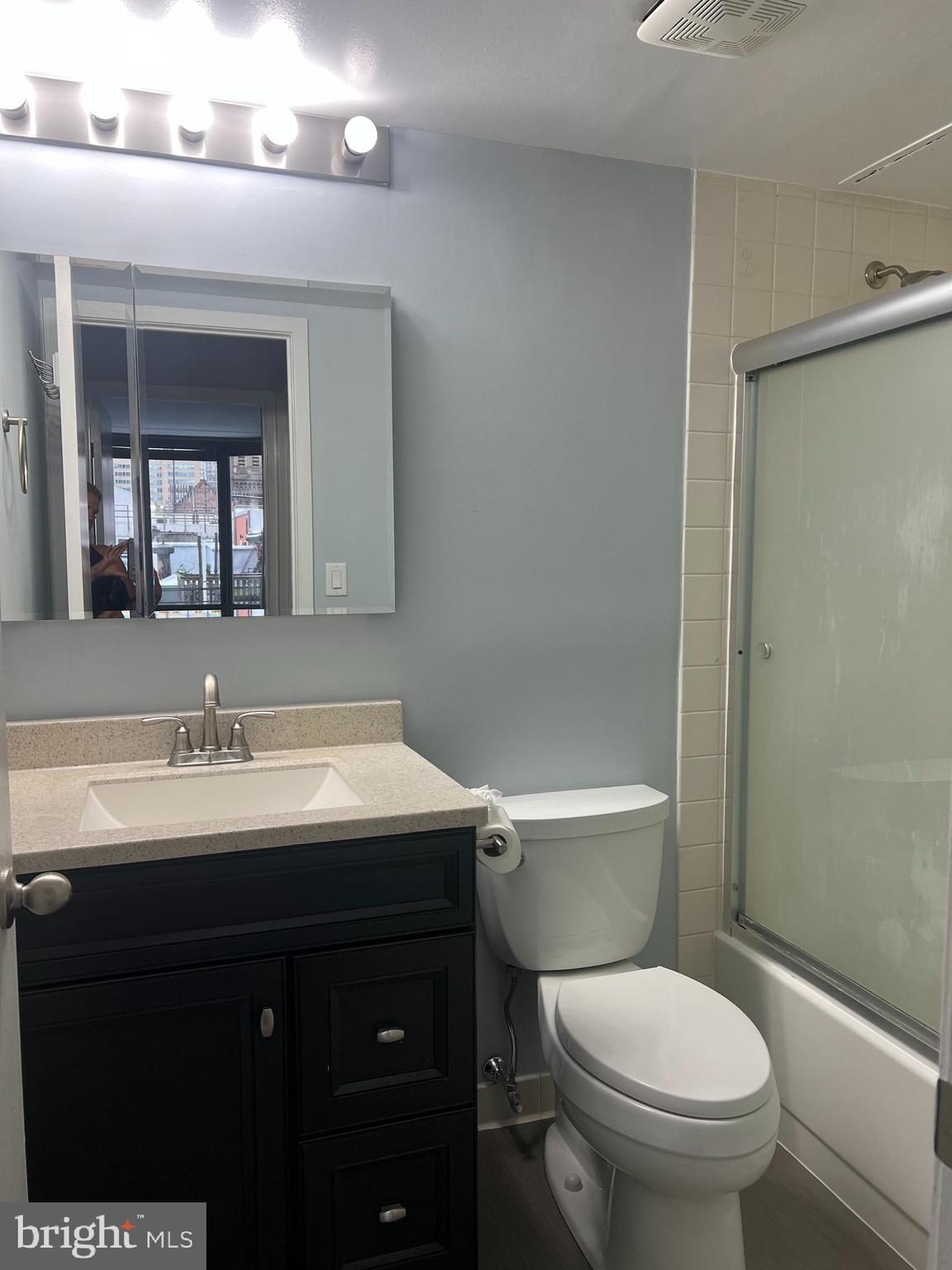 2020 Walnut Street, Unit 6C Philadelphia, PA 19103 - Photo 9 of 25 a bathroom with a toilet sink and mirror