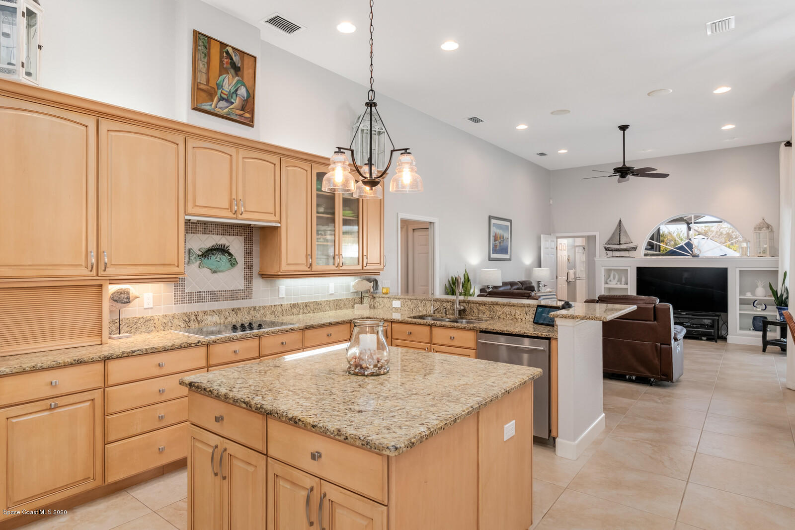 4050 Stoney Point Road Melbourne, FL 32940 - Photo 14 of 52 a kitchen with kitchen island granite countertop a sink cabinets and window