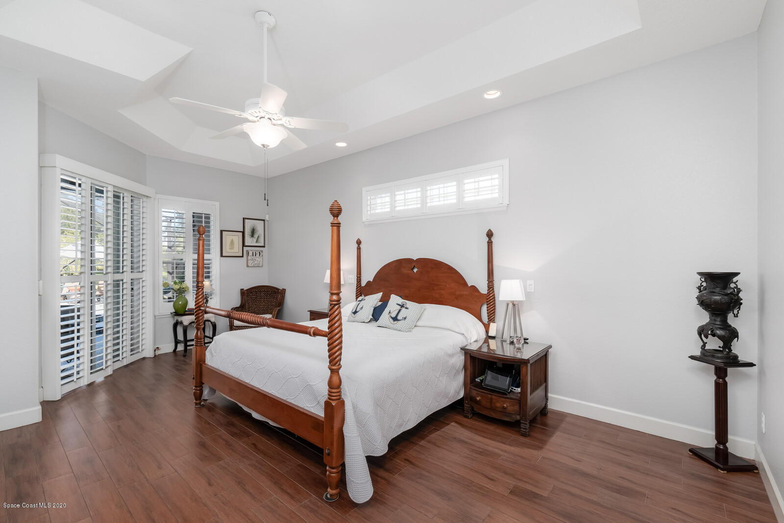 4050 Stoney Point Road Melbourne, FL 32940 - Photo 21 of 52 a bedroom with a bed and wooden floor