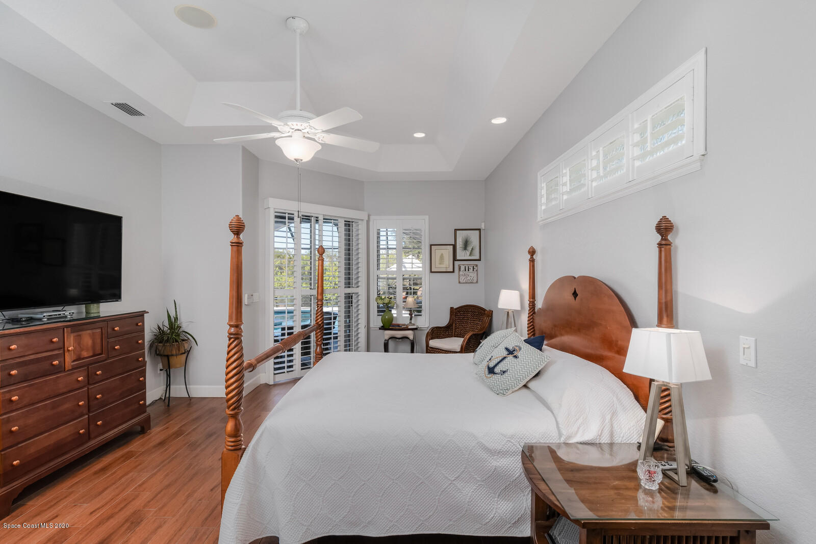 4050 Stoney Point Road Melbourne, FL 32940 - Photo 22 of 52 a large bedroom with bed and flat tv with wooden floor
