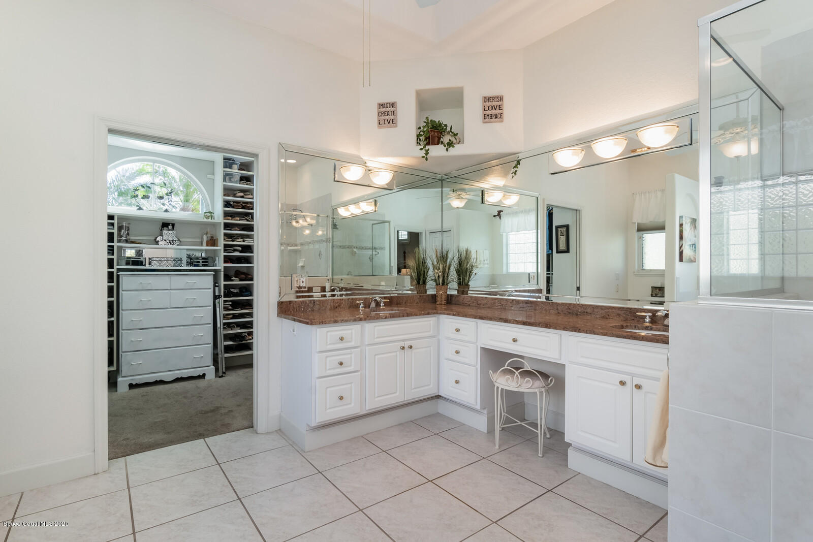 4050 Stoney Point Road Melbourne, FL 32940 - Photo 23 of 52 a spacious bathroom with a granite countertop sink mirror and cabinets