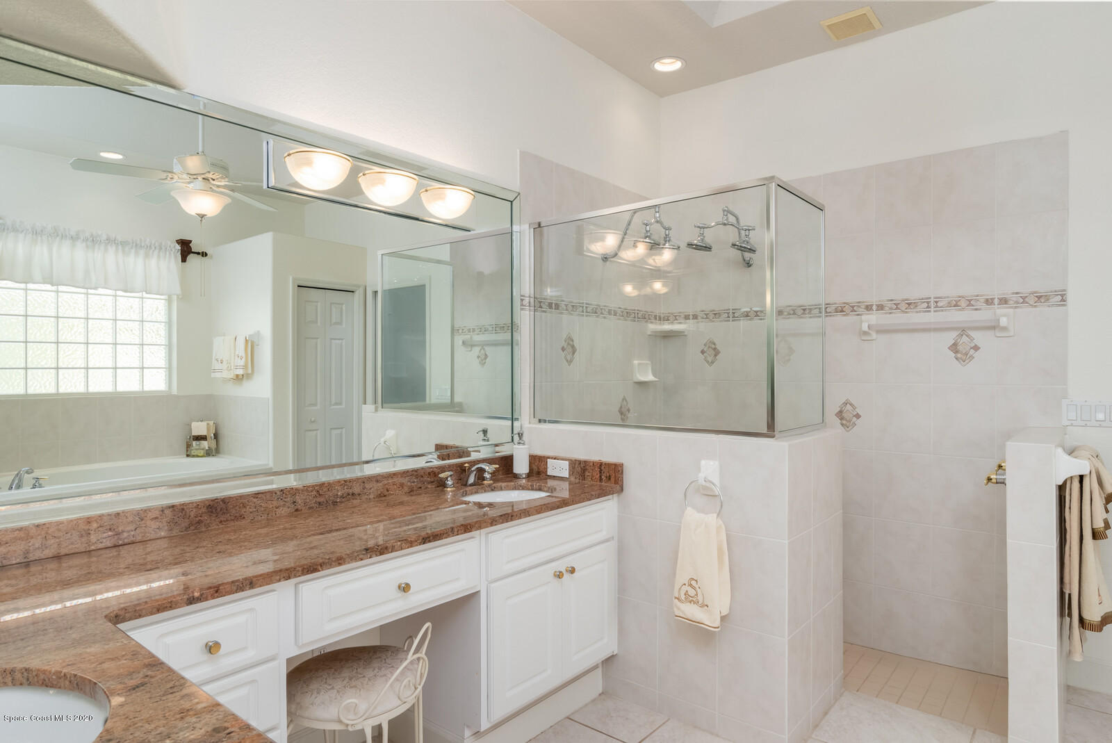 4050 Stoney Point Road Melbourne, FL 32940 - Photo 24 of 52 a bathroom with a granite countertop double vanity sink and mirror