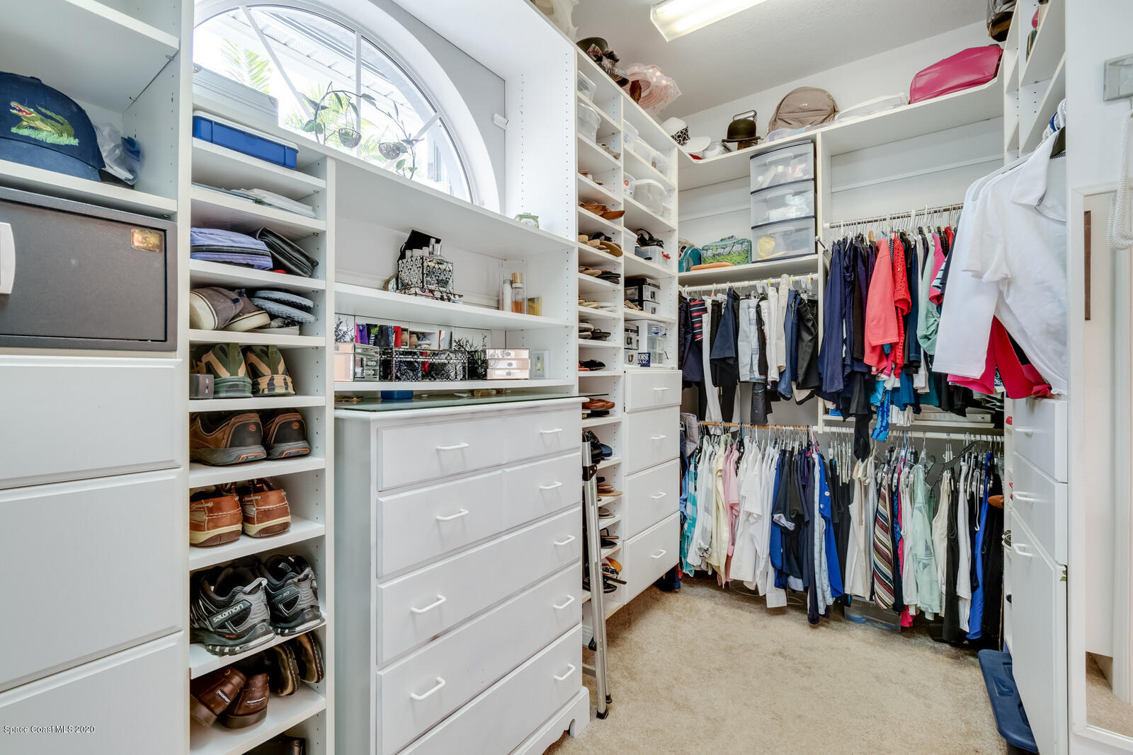 4050 Stoney Point Road Melbourne, FL 32940 - Photo 27 of 52 a view of walk in closet with clothes and shoes
