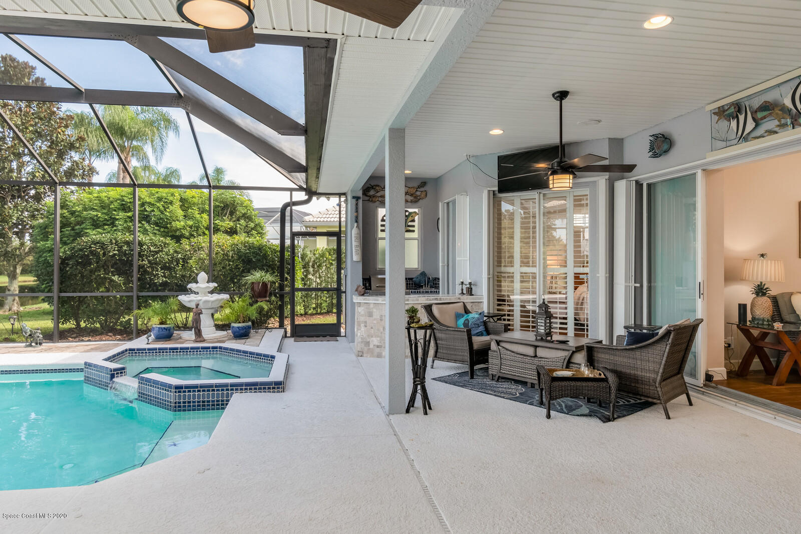 4050 Stoney Point Road Melbourne, FL 32940 - Photo 29 of 52 a living room with patio furniture and a floor to ceiling window
