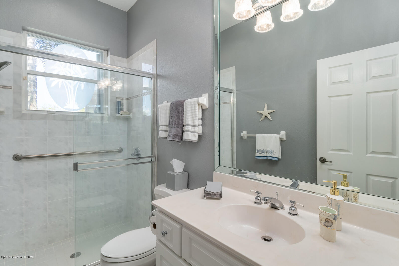 4050 Stoney Point Road Melbourne, FL 32940 - Photo 35 of 52 a bathroom with a sink a toilet and shower