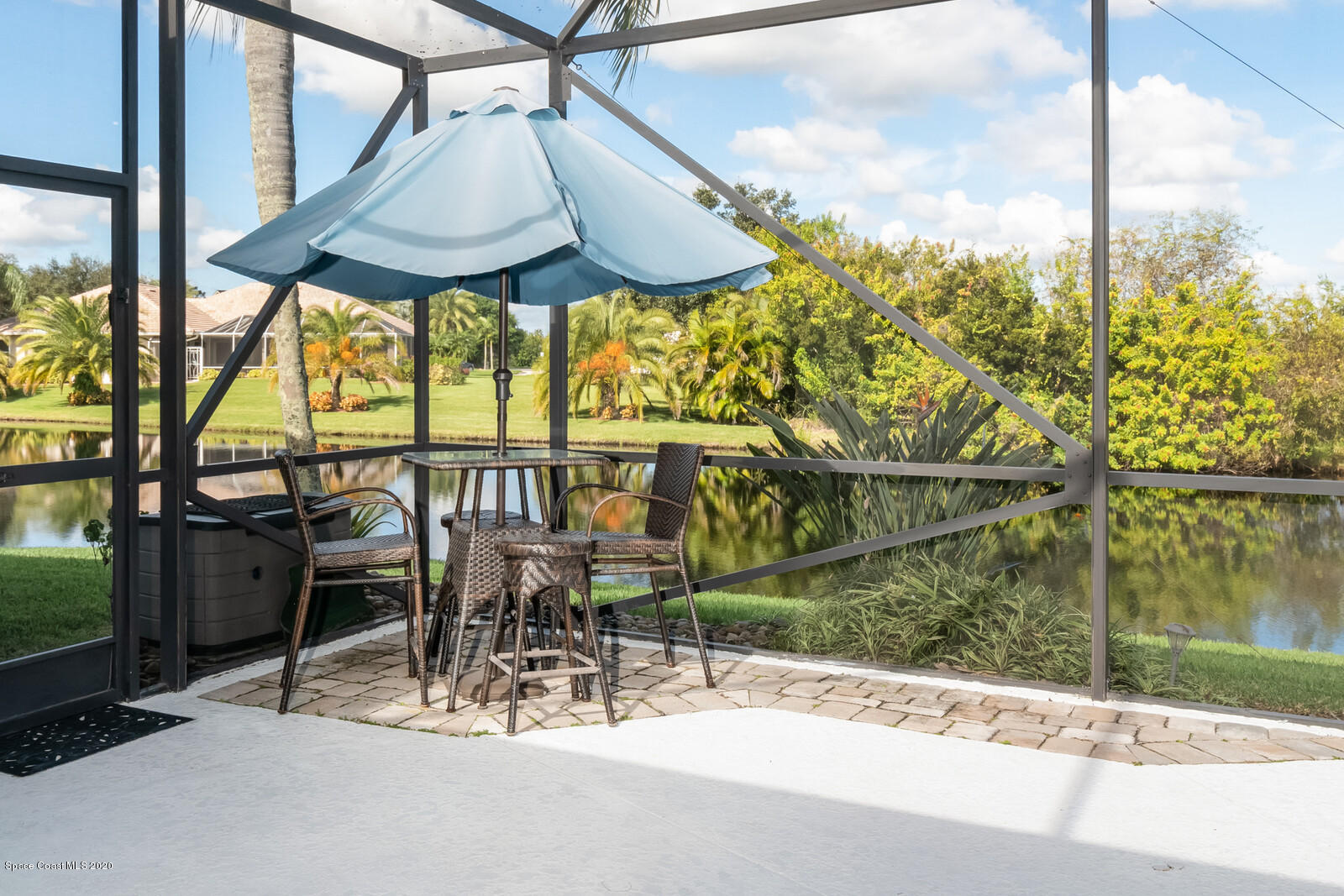 4050 Stoney Point Road Melbourne, FL 32940 - Photo 39 of 52 a view of a patio with table and chairs under an umbrella