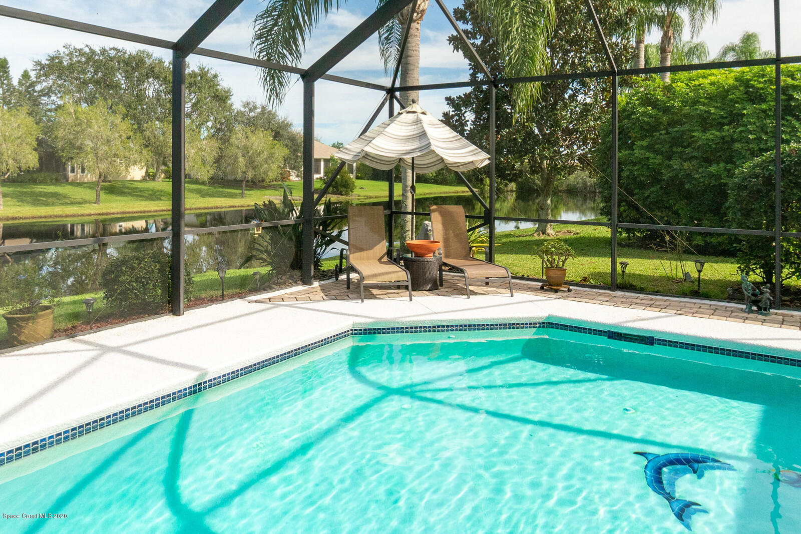 4050 Stoney Point Road Melbourne, FL 32940 - Photo 41 of 52 a swimming pool with outdoor seating and yard