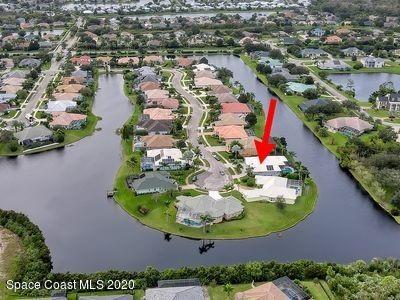 4050 Stoney Point Road Melbourne, FL 32940 - Photo 47 of 52 an aerial view of a house with a swimming pool yard and lake view in back