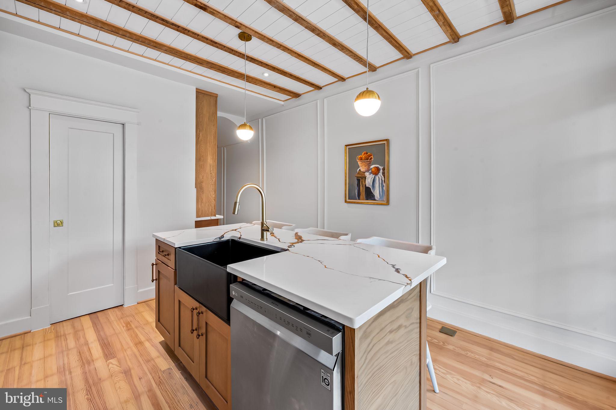 832 Union Avenue Baltimore, MD 21211 - Photo 17 of 43 a kitchen with a sink and a refrigerator
