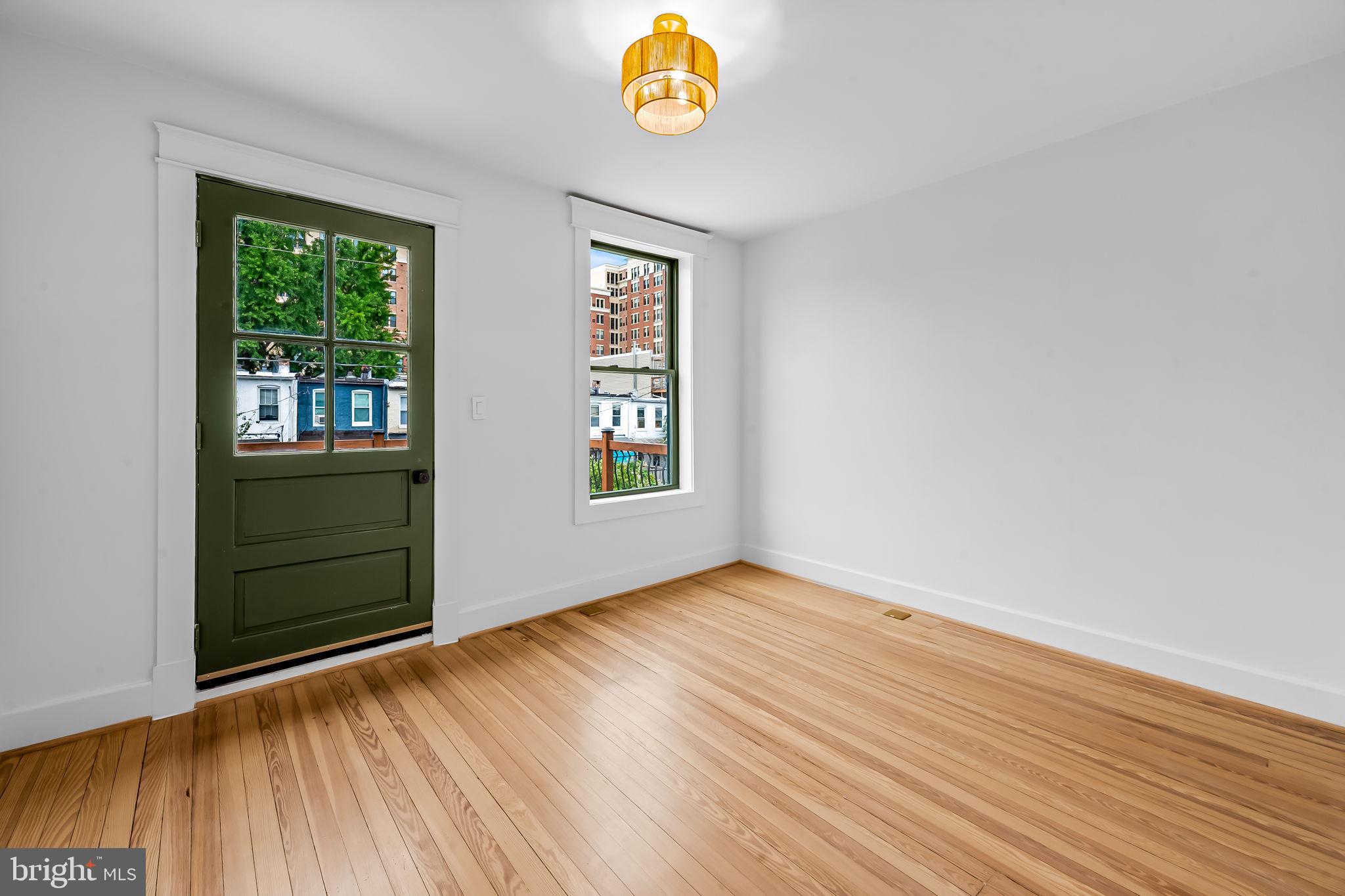 832 Union Avenue Baltimore, MD 21211 - Photo 29 of 43 an empty room with window and wooden floor