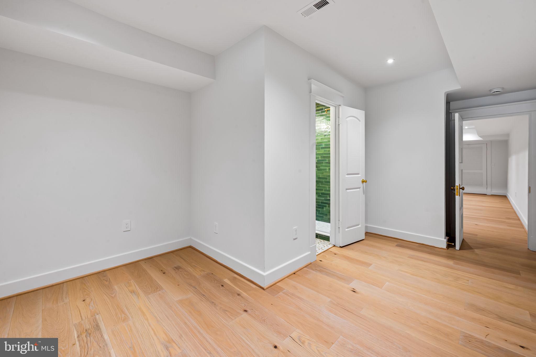 832 Union Avenue Baltimore, MD 21211 - Photo 35 of 43 wooden floor in an empty room with a window