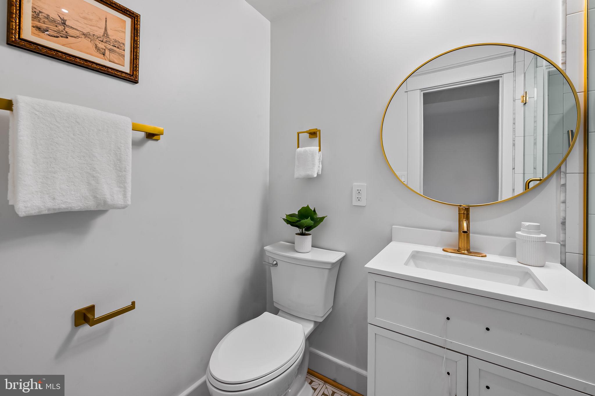 832 Union Avenue Baltimore, MD 21211 - Photo 37 of 43 a bathroom with a toilet a sink and mirror