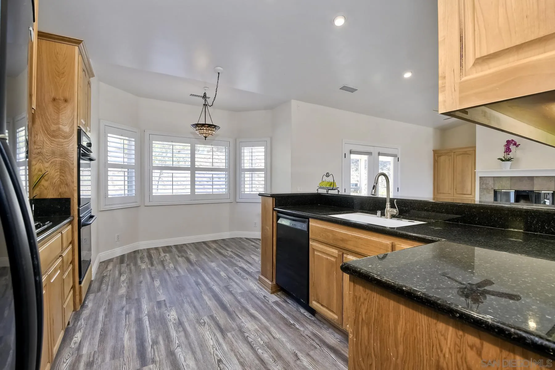 1550 Alturas Road Fallbrook, CA 92028 - Photo 10 of 31 a large kitchen with granite countertop a large window a sink and stainless steel appliances