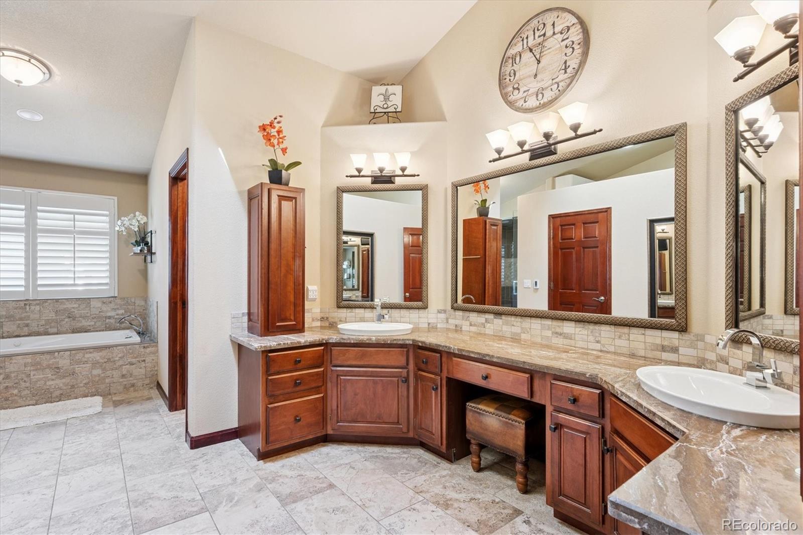 7804 Silverweed Way Lone Tree, CO 80124 - Photo 13 of 32 a bathroom with a sink a vanity and a large mirror