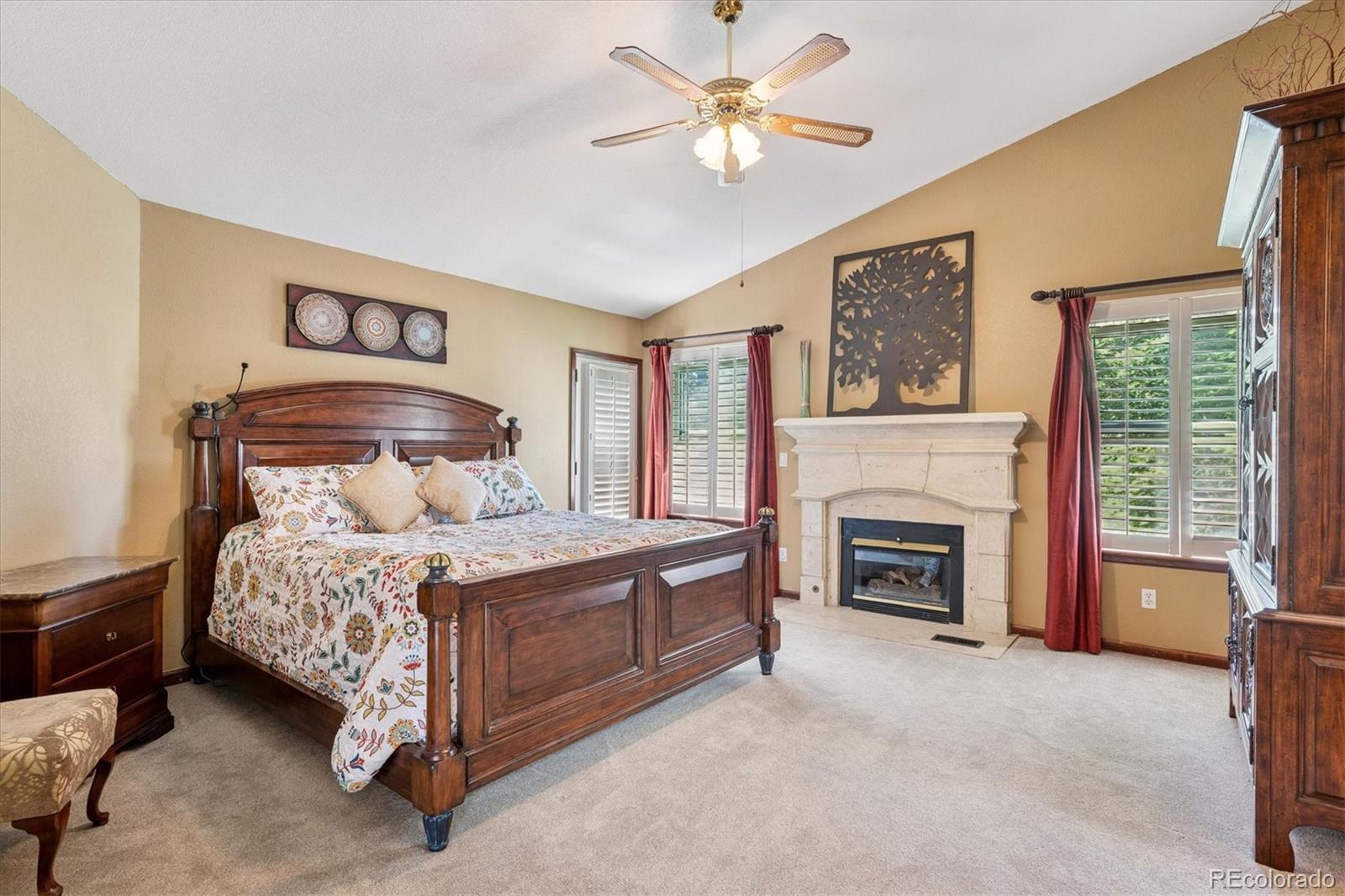 7804 Silverweed Way Lone Tree, CO 80124 - Photo 14 of 32 a bedroom with a bed and a fireplace