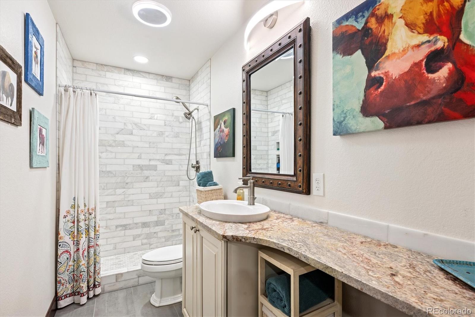 7804 Silverweed Way Lone Tree, CO 80124 - Photo 16 of 32 a bathroom with a granite countertop sink toilet and shower
