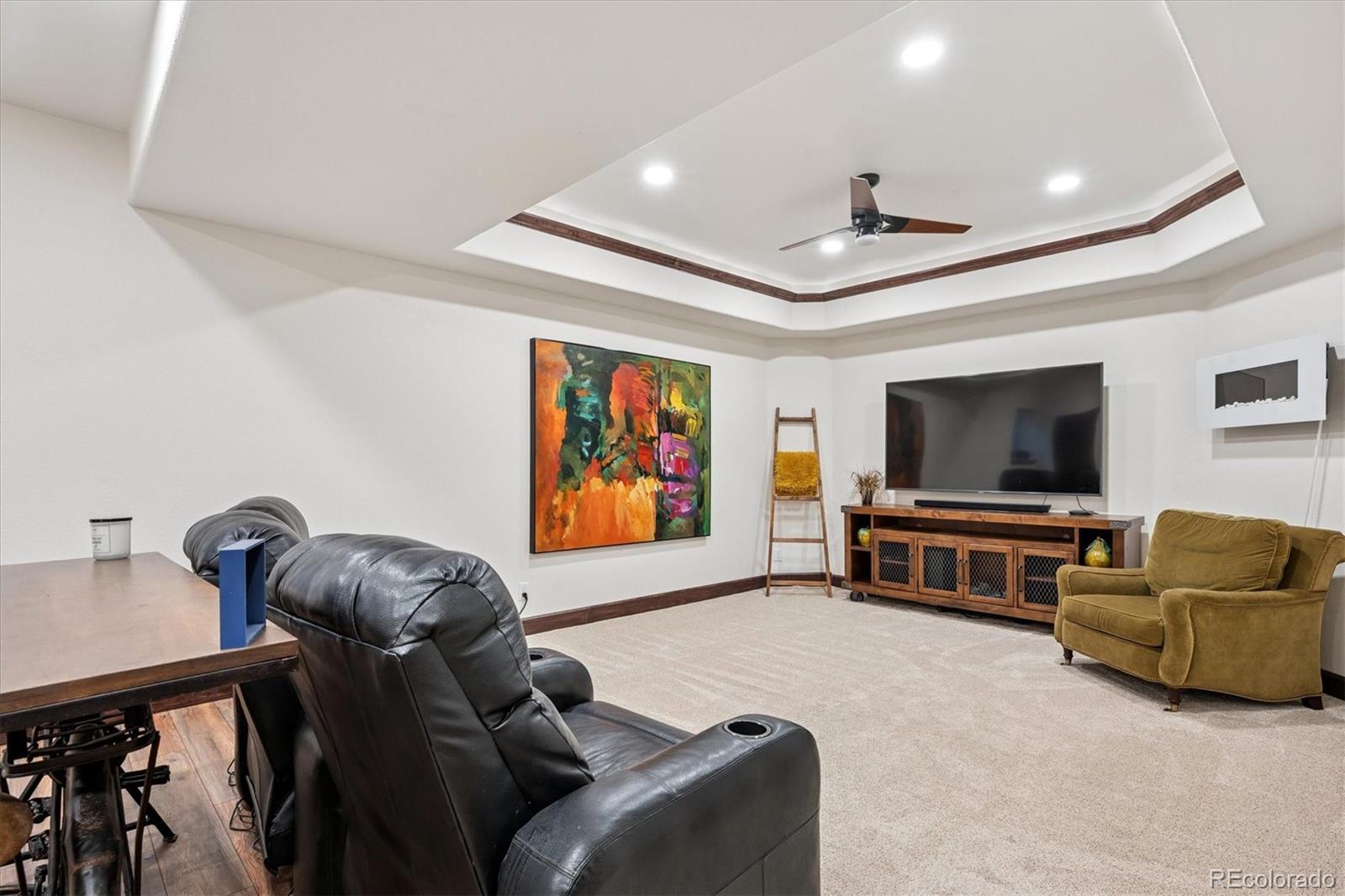 7804 Silverweed Way Lone Tree, CO 80124 - Photo 19 of 32 a living room with furniture and a flat screen tv