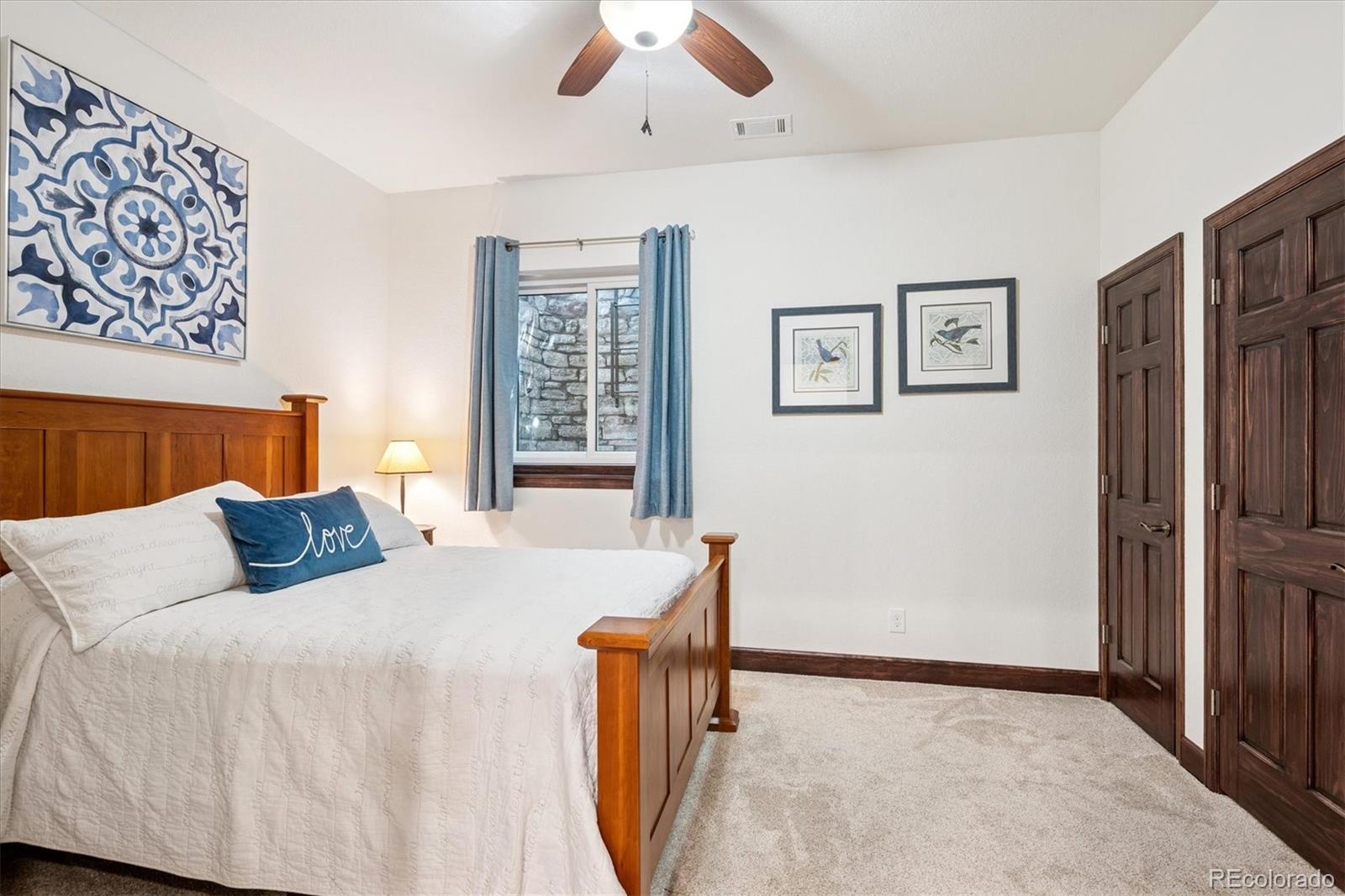 7804 Silverweed Way Lone Tree, CO 80124 - Photo 21 of 32 a bedroom with a bed and a large window