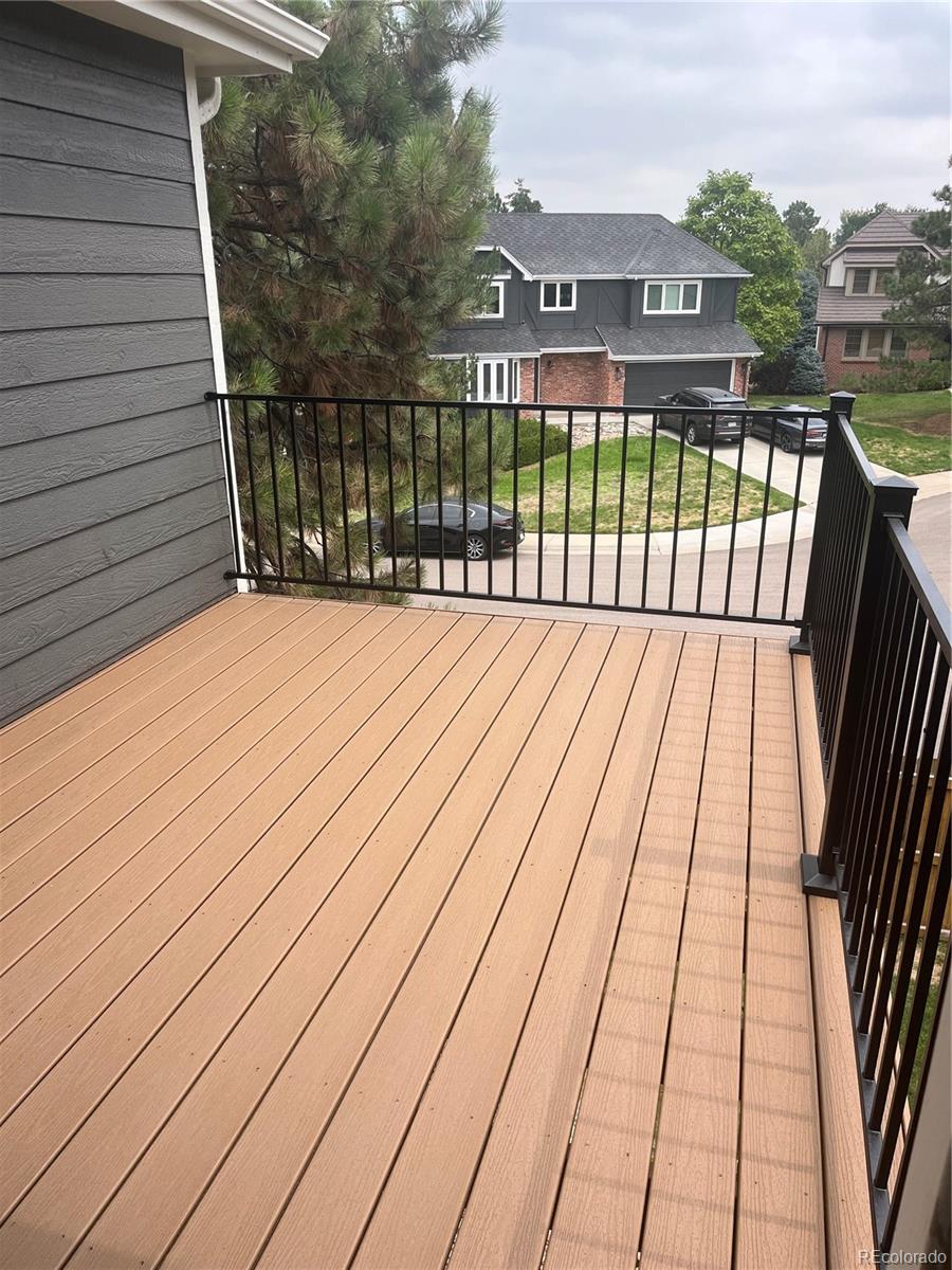 7804 Silverweed Way Lone Tree, CO 80124 - Photo 26 of 32 a view of balcony with wooden floor and fence and a floor to ceiling window