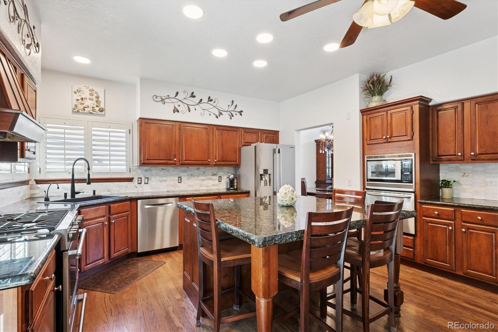 7804 Silverweed Way Lone Tree, CO 80124 - Photo 3 of 32 a large kitchen with a table and chairs in it